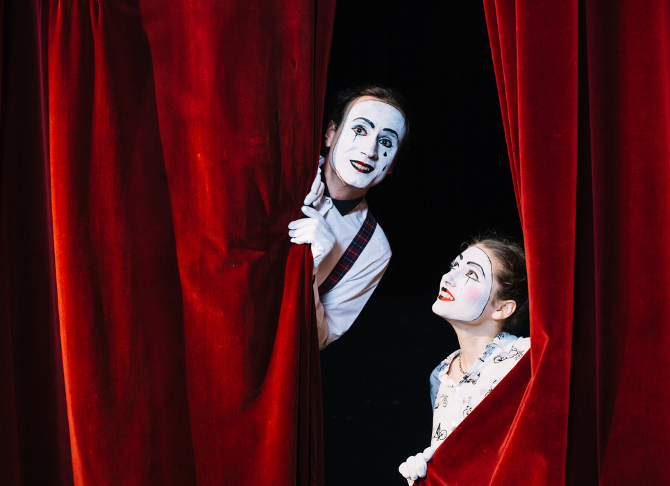hjj6ldzof5_____smiling-female-mime-artist-looking-male-mime-artist-peeking-from-curtain