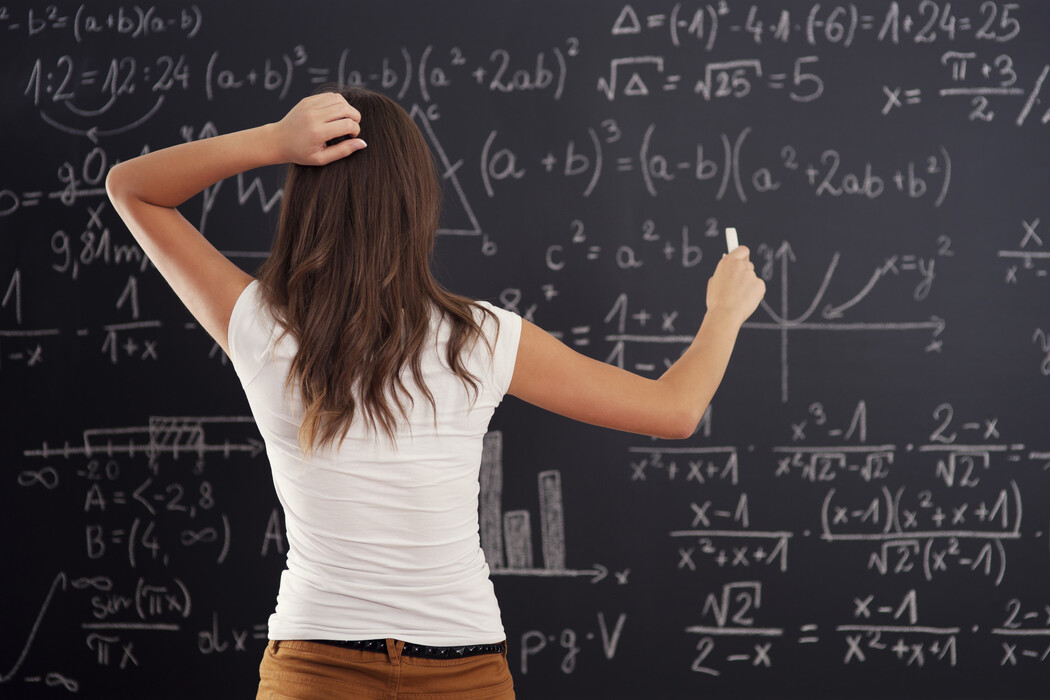 6joxx3qa6b_____young-woman-looking-math-problem-blackboard